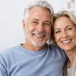 An older couple, smiling.