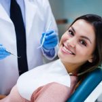 A patient smiling while learning about dental implant aftercare.