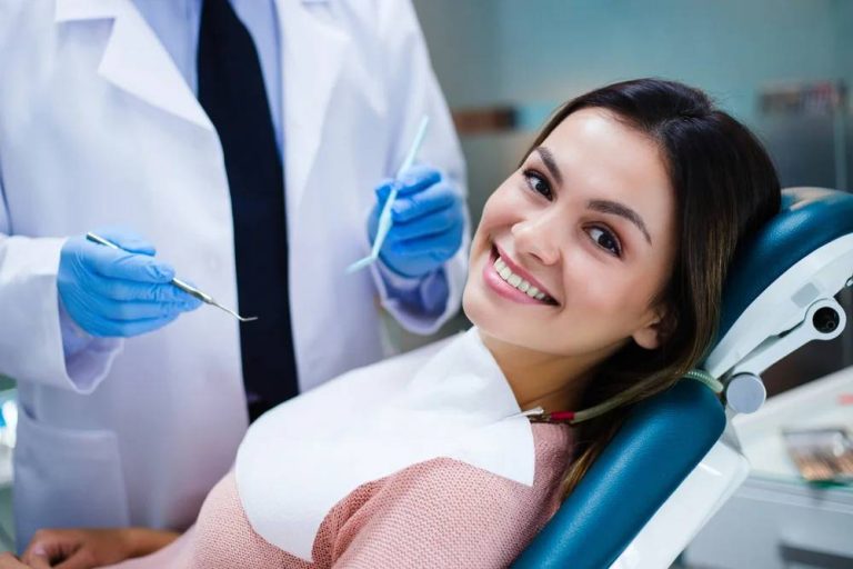 A patient smiling while learning about dental implant aftercare.